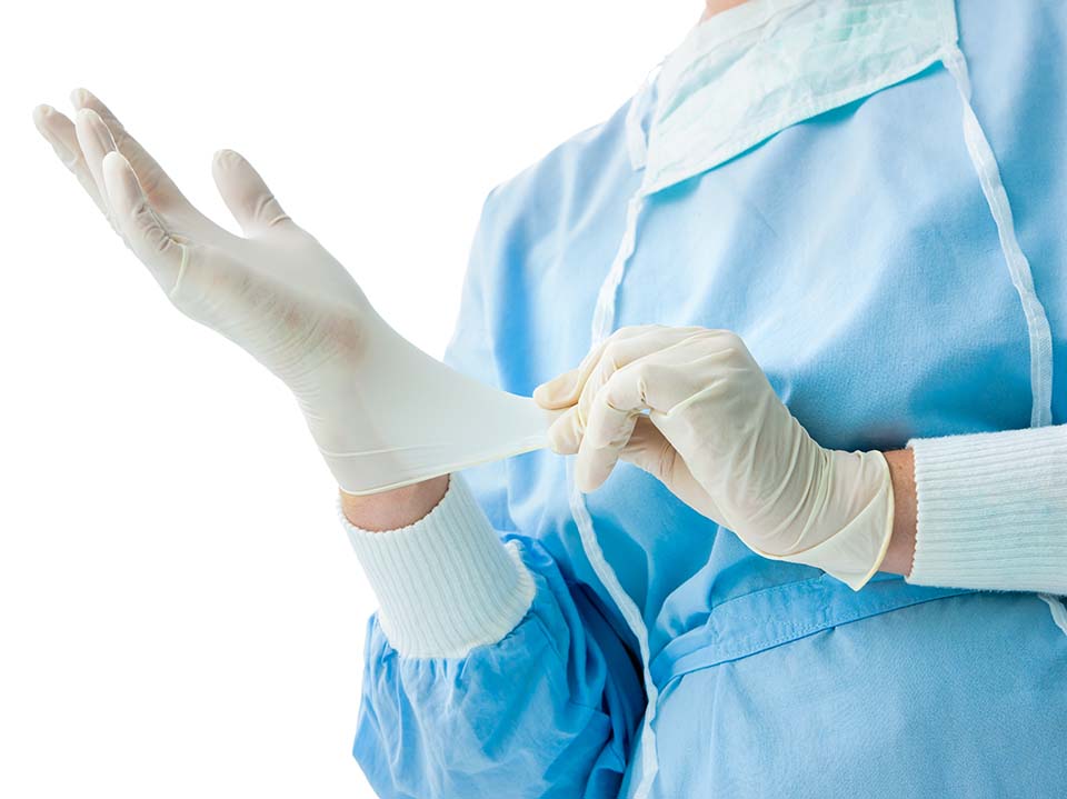 Doctor,Putting,On,White,Sterilized,Surgical,Gloves